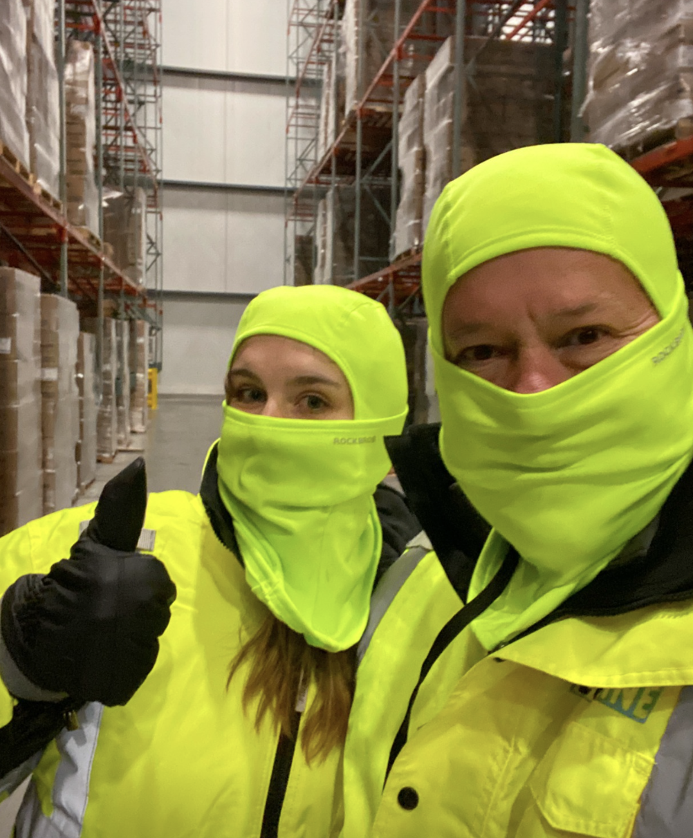 Two people wearing cold protective gear at an installation